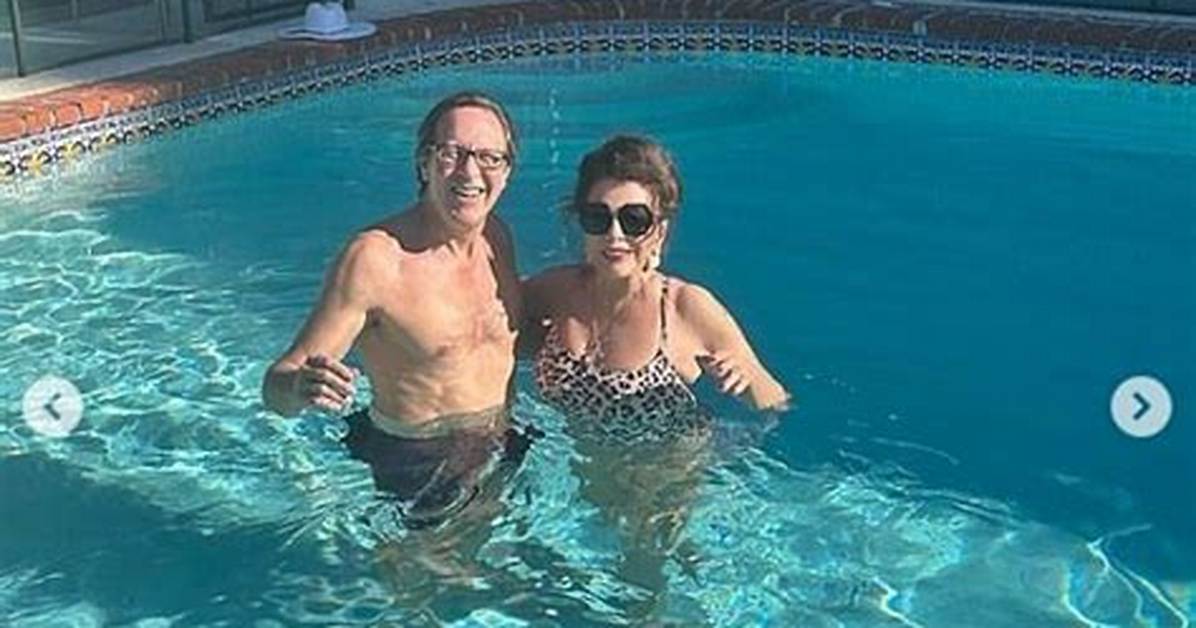 Dame Joan Collins, 89, Rocks Leopard Swimsuit for Swim with Husband Percy Gisbon, 57