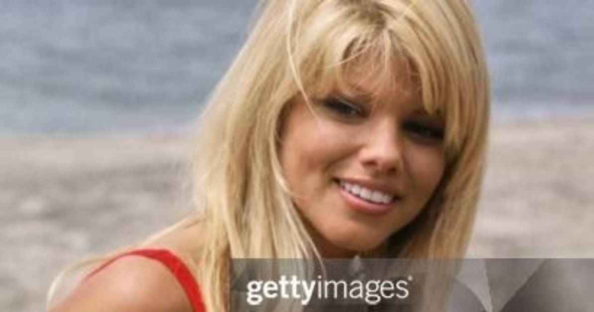 Donna D’errico Rocks Red ‘Baywatch’ Swimsuit to Celebrate Her 55Th Birthday in Sexy Photo