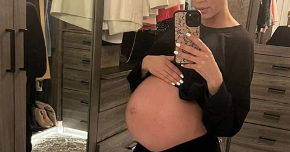 Heather Rae Young Covers Baby Bump in Black Lace Dress as She Kisses Tarek El Moussa