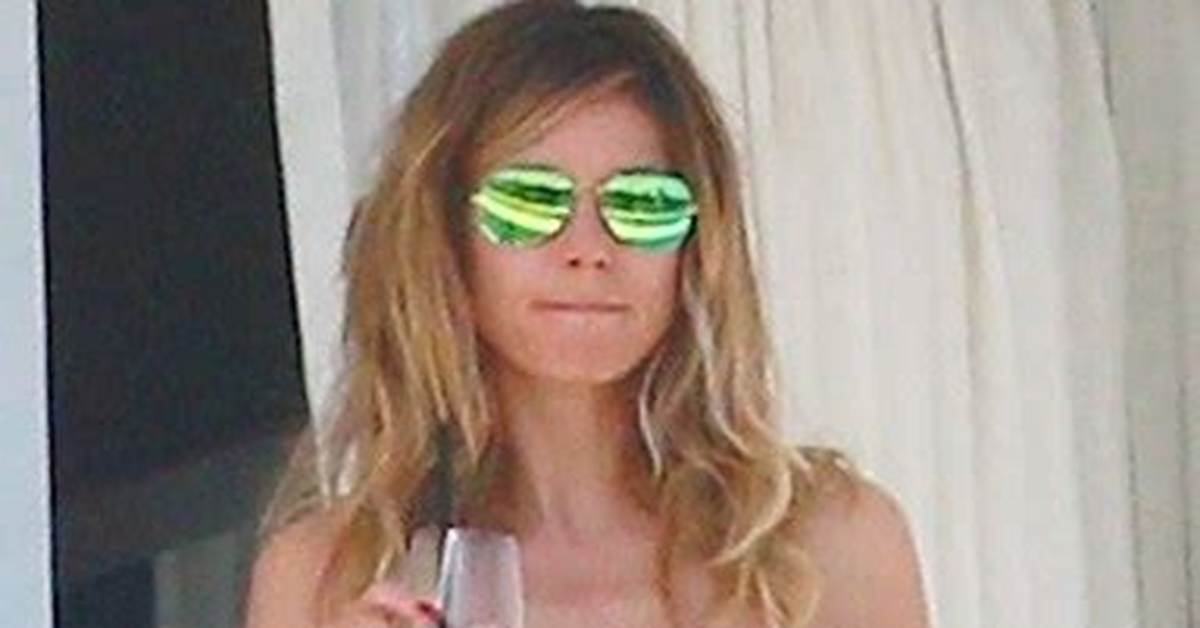 Heidi Klum, 50, Rocks Cutout Floral Swimsuit While Serving Plates of Food on Vacay: Photos