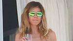 Heidi Klum, 50, Rocks Cutout Floral Swimsuit While Serving Plates of Food on Vacay: Photos