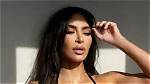 Kim Kardashian Rocks a Black Bikini to Sunbathe on a Hammock in the Water