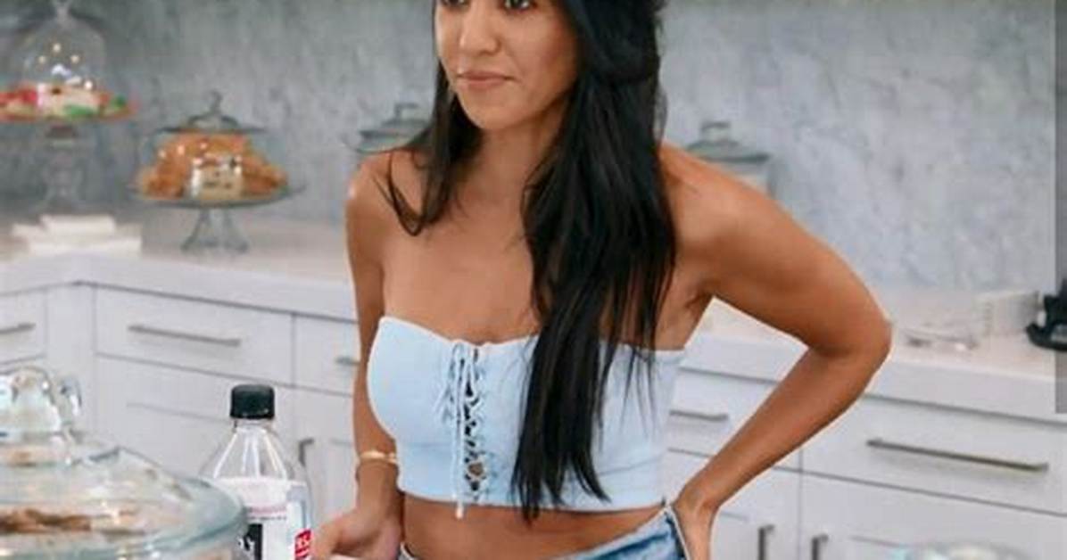 Kourtney Kardashian Shows How to Pair a Black Strapless Top with Dark Jeans for an Elongating Look