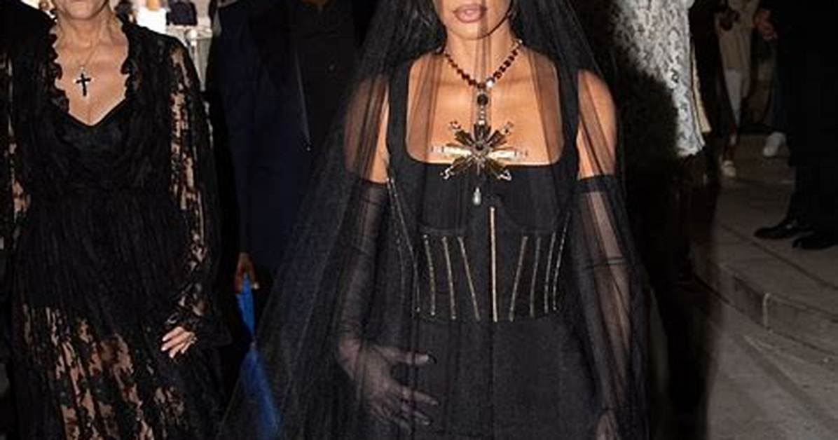Kourtney Kardashian Stuns in Cutout Midi Dress as She Poses Seductively on Bed