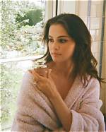 Selena Gomez Rocks Nothing but a Bathrobe While Lounging in Seaside Hotel Room in Sexy ‘Love On’ Music Video