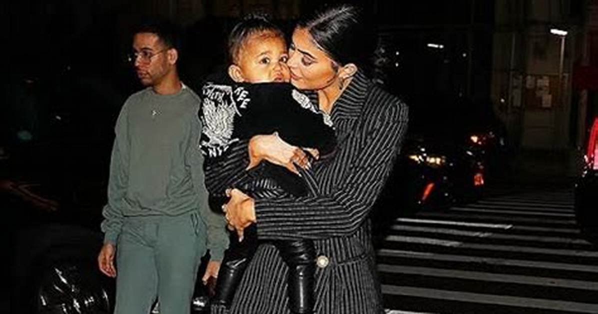 Stormi Webster, 1, Sweetly Kisses Cousin Psalm West, 8 Mos. — See Cute Photo